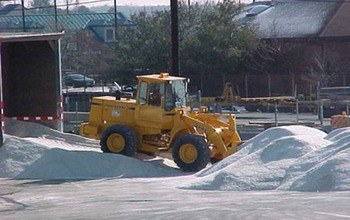 A Maryland State Highway Administration loader moves salt stored for use in winter.